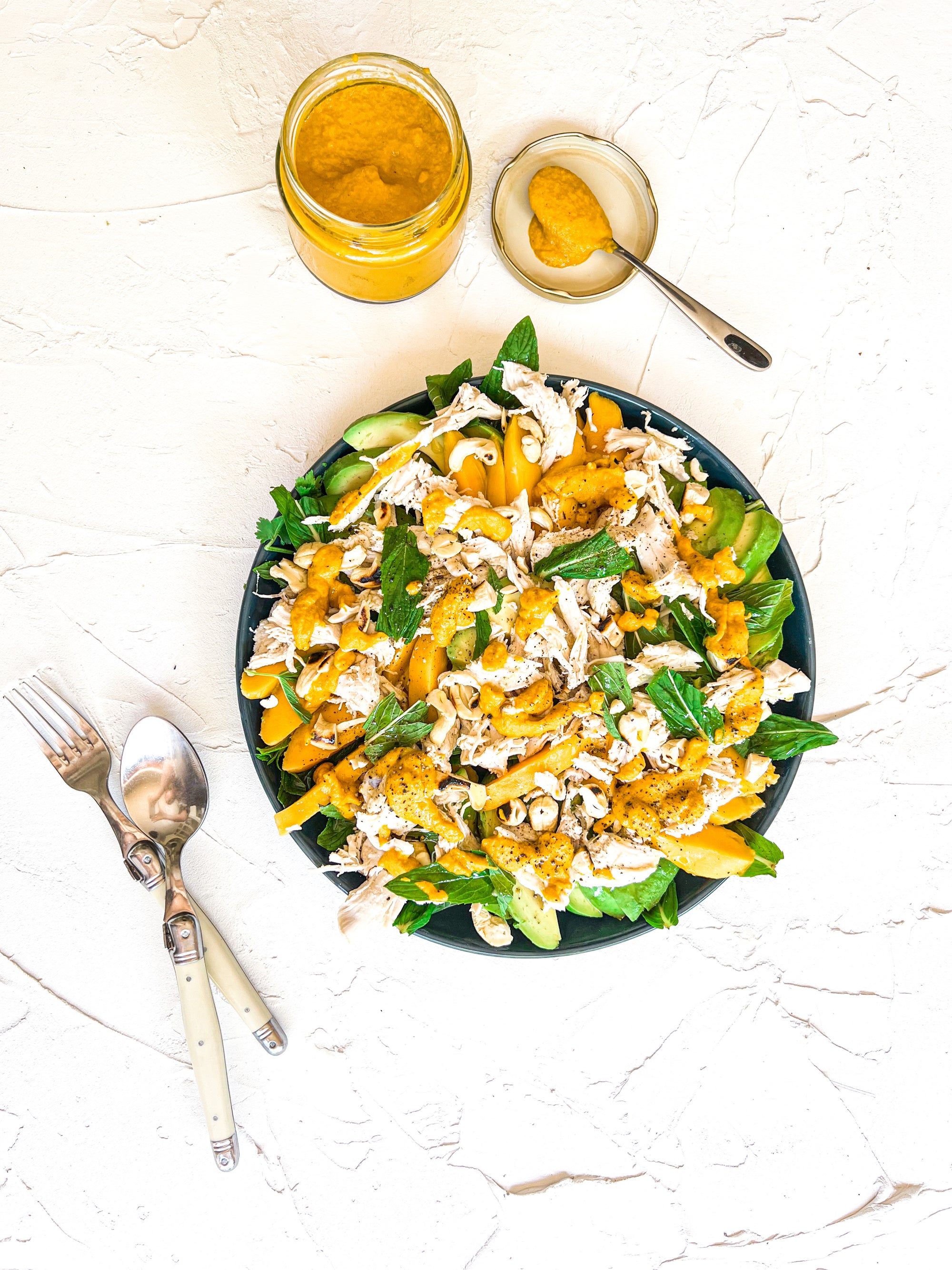 Mango, avocado and poached chicken salad with fragrant herbs and carrot ginger dressing
